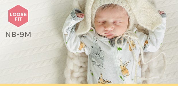 Newborn baby wearing loose fit Burt's Bees Baby rabbit print pajamas